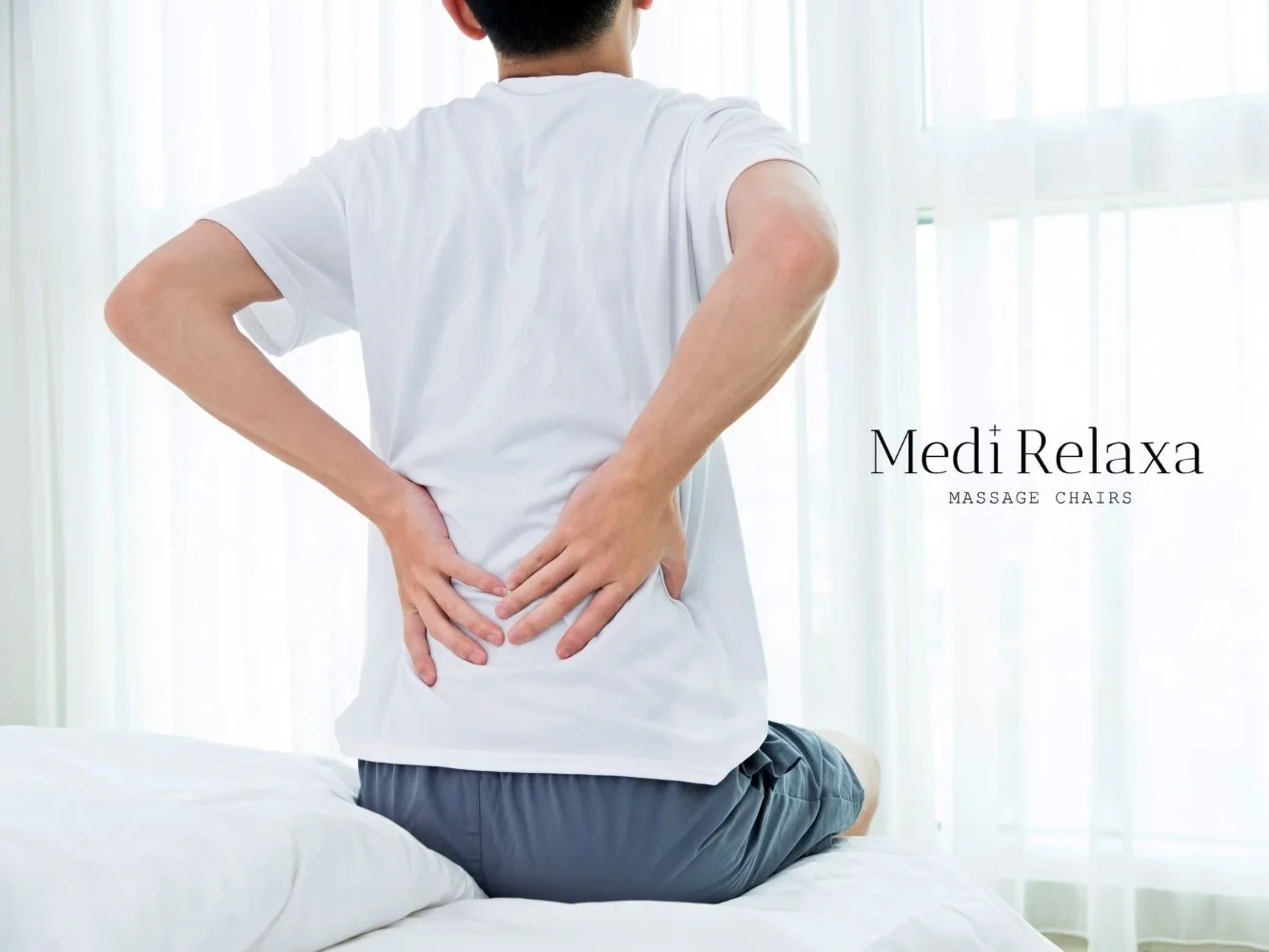 person with low back pain holding back