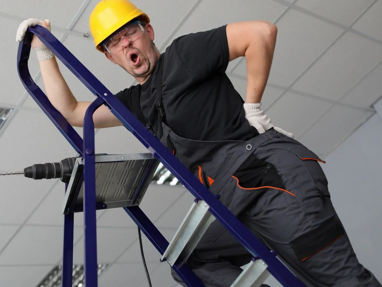 workman on ladder suffering acute lumbago
